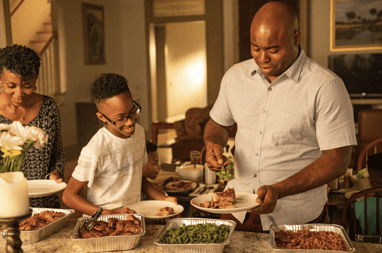 Family serving dinner catered to their home